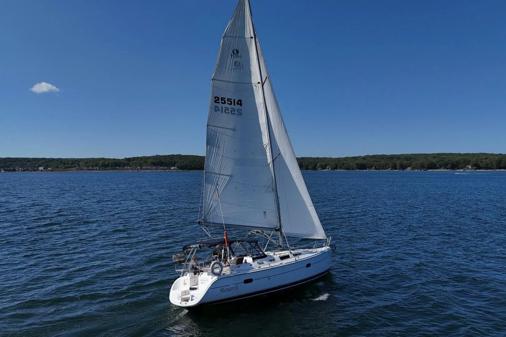 Sailboat "Monarch" on open water, Hunter 356 model, 2003, under clear blue sky.