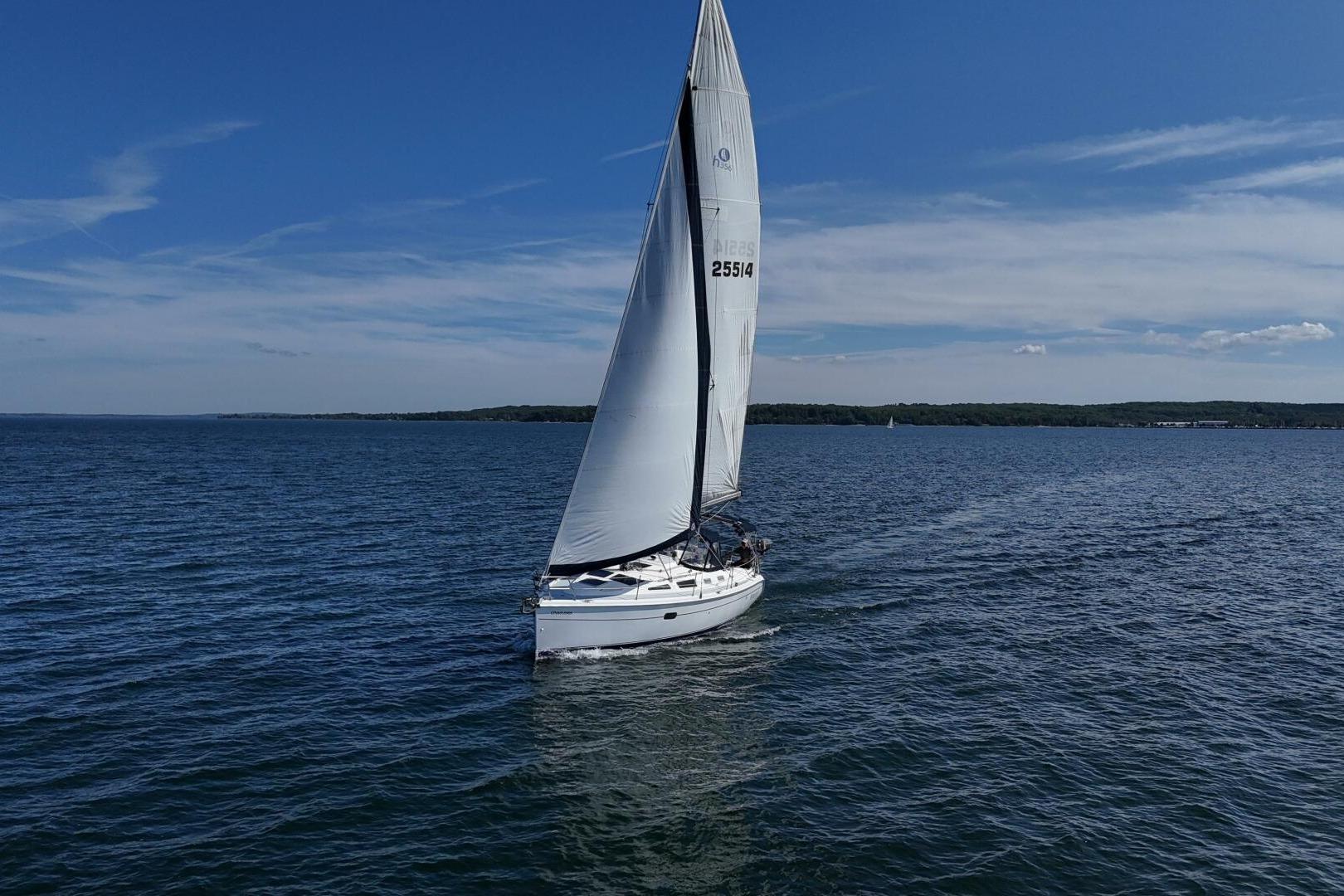 Sailboat Hunter 356 (2003) cruising on a sunny day over calm blue waters.