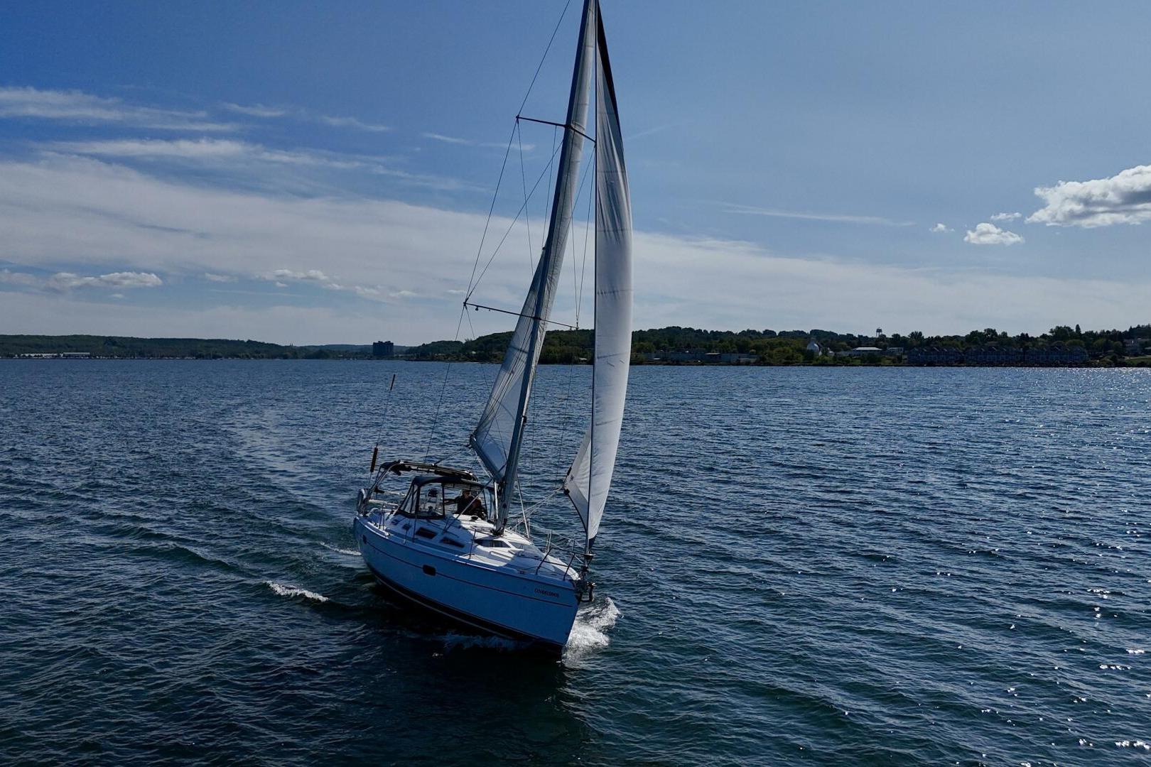 Sailboat Hunter 356 (2003) cruising on a sunny day with clear skies.