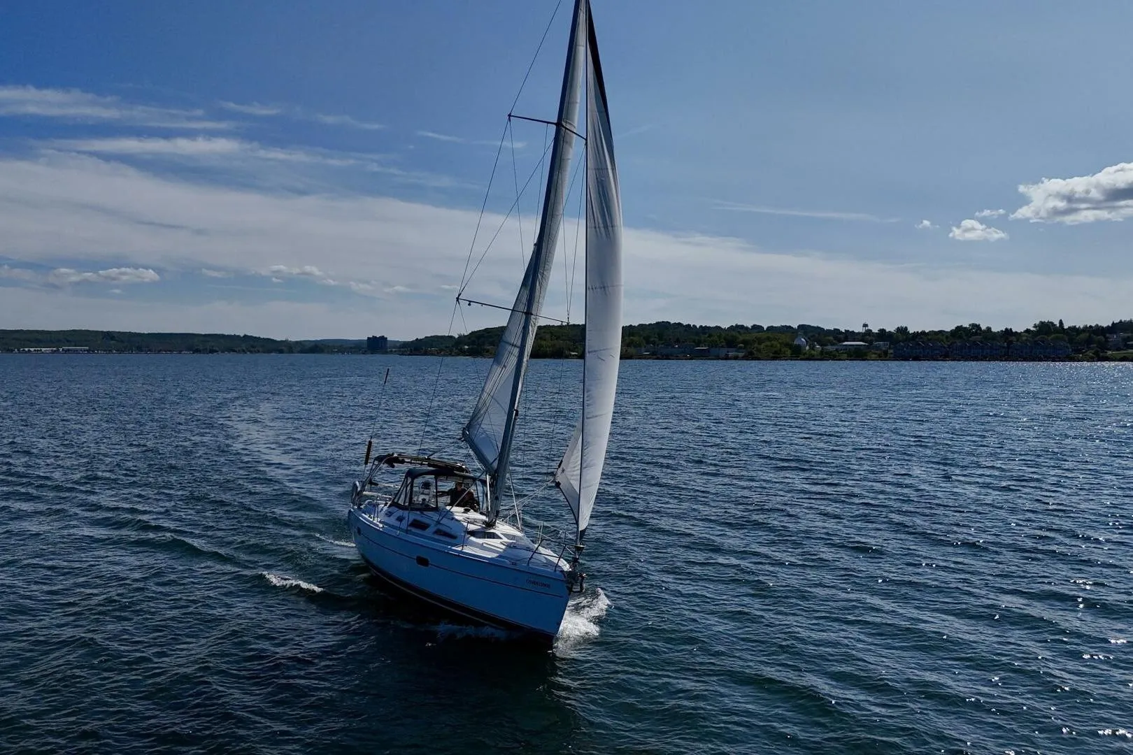 Sailboat Hunter 356 (2003) cruising on a sunny day with clear skies.