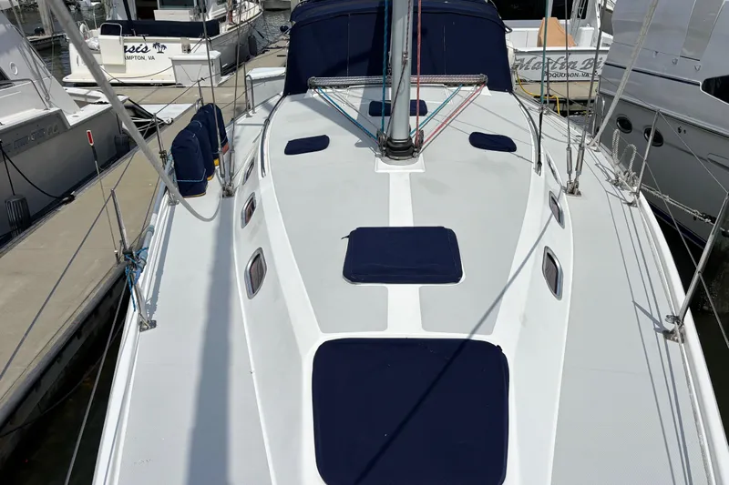  Yacht Photos Pics 2006 Catalina 42 MkII sailboat deck view at marina, featuring sleek design and blue accents.