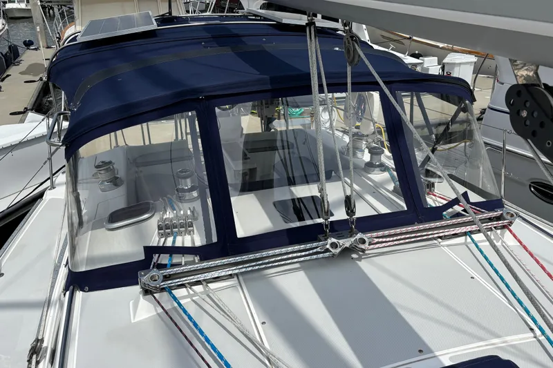  Yacht Photos Pics 2006 Catalina 42 MkII sailboat with blue dodger and visible rigging at dock.