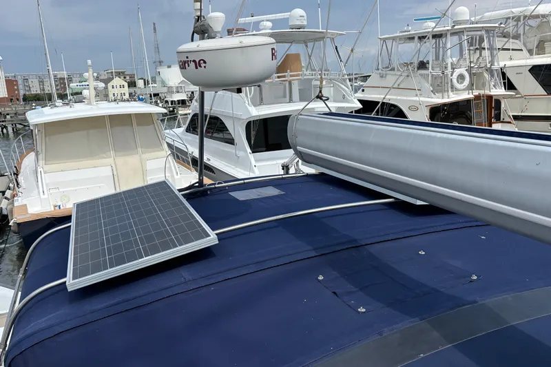  Yacht Photos Pics Catalina 42 MkII 2006 sailboat with solar panel and radar, docked among other boats.