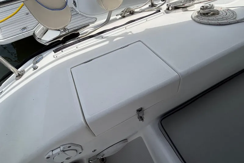  Yacht Photos Pics Deck view of a 2006 Catalina 42 MkII sailboat, featuring storage compartment and coiled rope.