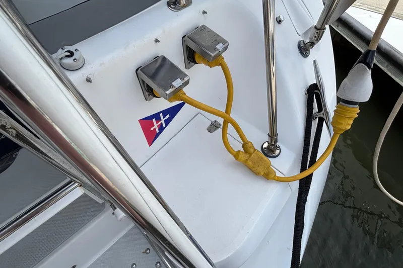  Yacht Photos Pics Catalina 42 MkII 2006 sailboat with yellow shore power cables and nautical emblem.