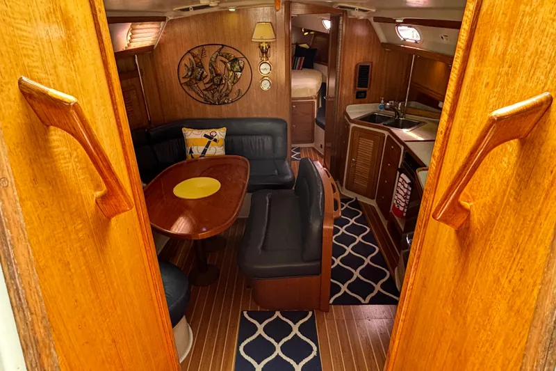  Yacht Photos Pics Interior of 2006 Catalina 42 MkII sailboat with cozy seating and wooden finishes.