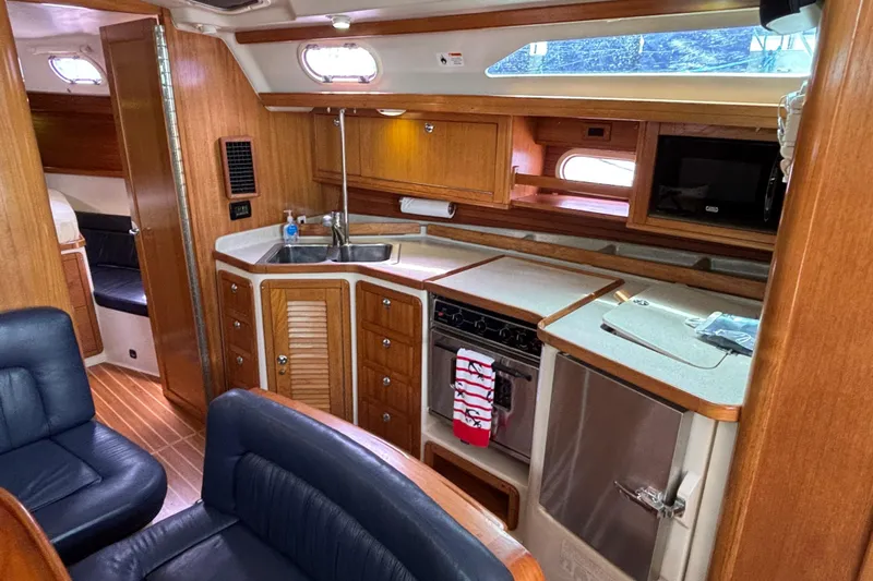  Yacht Photos Pics Interior of 2006 Catalina 42 MkII yacht with wooden cabinetry and modern kitchen amenities.
