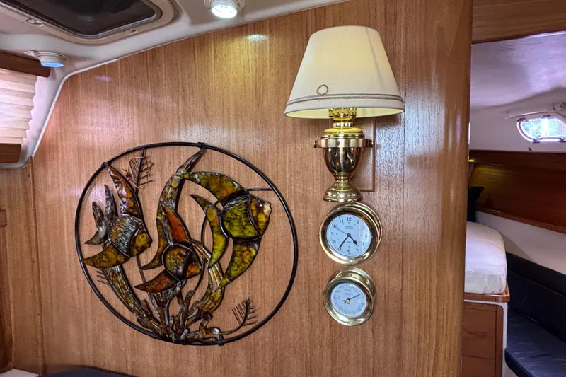  Yacht Photos Pics Interior of 2006 Catalina 42 MkII yacht with fish wall art and brass clock.