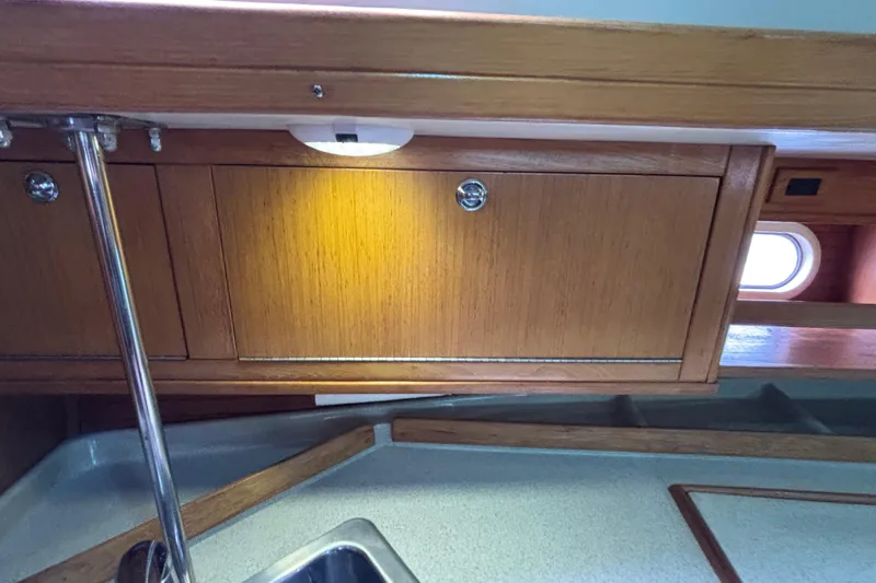  Yacht Photos Pics Interior of 2006 Catalina 42 MkII sailboat with wooden cabinetry and stainless steel fixtures.