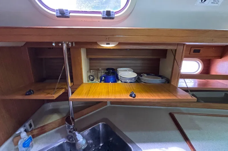  Yacht Photos Pics Interior of 2006 Catalina 42 MkII sailboat with wooden cabinets and kitchenware.