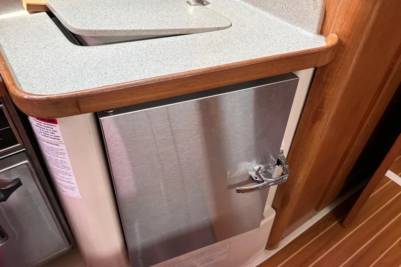  Yacht Photos Pics Galley area of 2006 Catalina 42 MkII sailboat with stainless steel fridge.