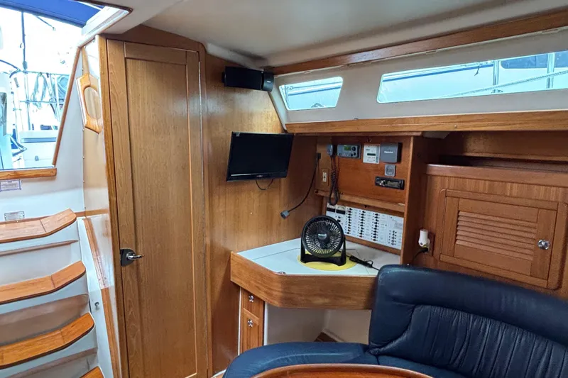  Yacht Photos Pics Interior of 2006 Catalina 42 MkII sailboat with wood paneling and navigation equipment.