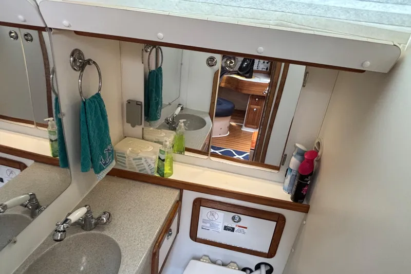  Yacht Photos Pics Bathroom interior of 2006 Catalina 42 MkII yacht with sink, mirror, and toiletries.