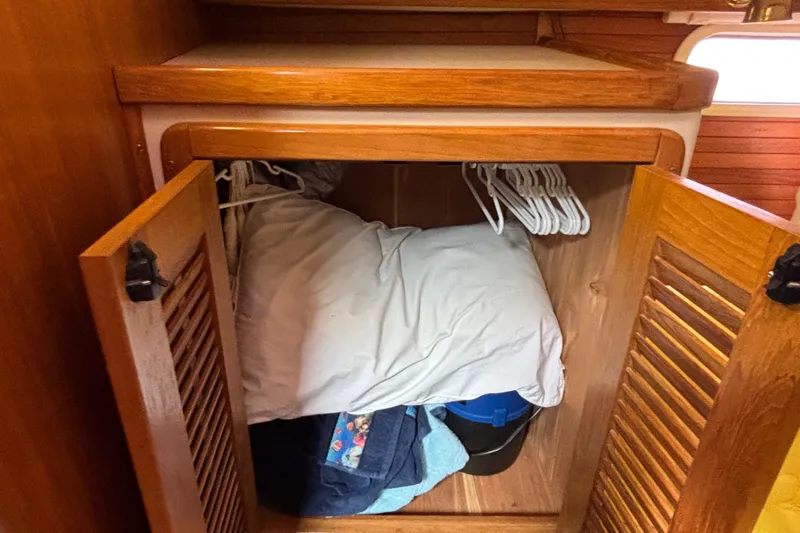  Yacht Photos Pics Wooden closet interior on 2006 Catalina 42 MkII sailboat with hangers and bedding.