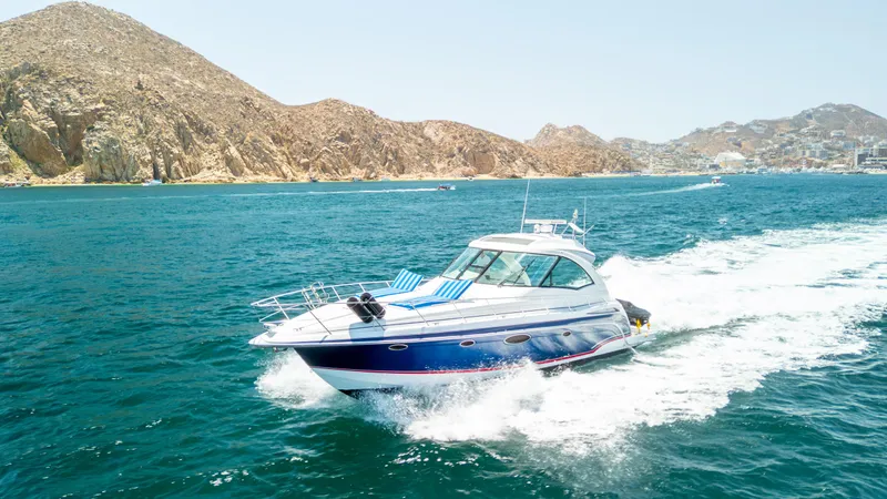 Baja 22 With Dry Storage In Cabo San Lucas Yacht Photos Pics 2007 Formula 45 Yacht cruising on blue ocean near rocky coastline.