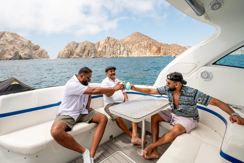 Baja 22 With Dry Storage In Cabo San Lucas Yacht Photos Pics Men enjoying drinks on a 2007 Formula 45 Yacht, with scenic ocean and rocky cliffs.