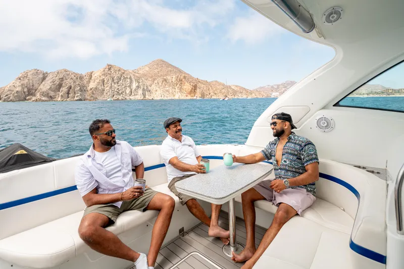 Baja 22 With Dry Storage In Cabo San Lucas Yacht Photos Pics Three men relaxing on a 2007 Formula 45 Yacht, scenic ocean backdrop.