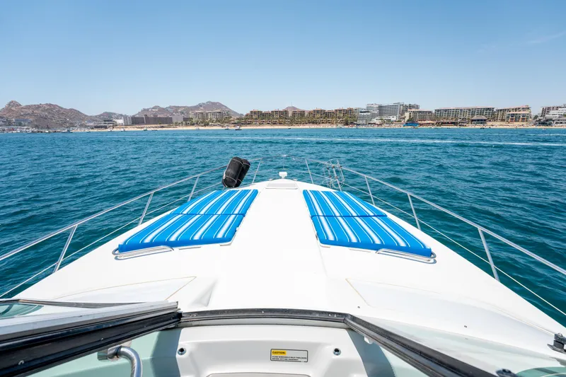 Baja 22 With Dry Storage In Cabo San Lucas Yacht Photos Pics 2007 Formula 45 Yacht cruising on blue ocean near coastal cityscape.