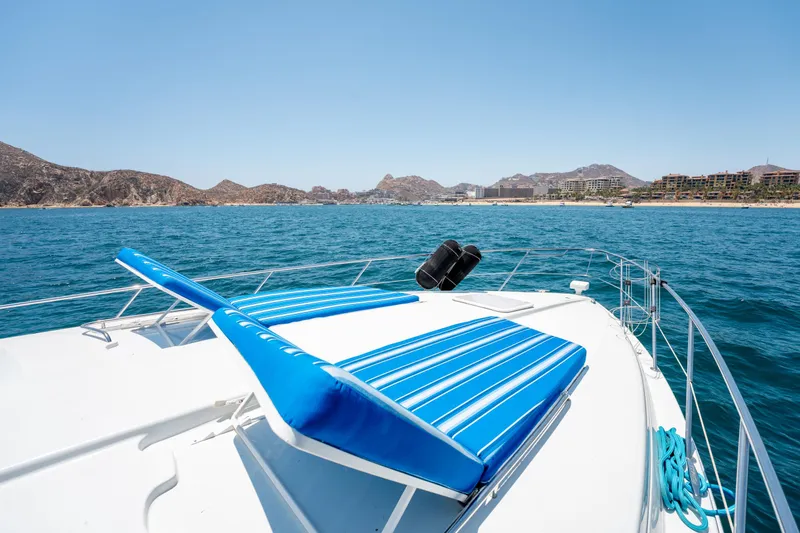 Baja 22 With Dry Storage In Cabo San Lucas Yacht Photos Pics 2007 Formula 45 Yacht with blue sun loungers on deck, ocean and coastline in background.
