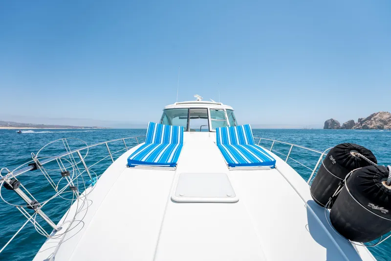 Baja 22 With Dry Storage In Cabo San Lucas Yacht Photos Pics 2007 Formula 45 Yacht with striped loungers on deck, cruising in clear blue waters.