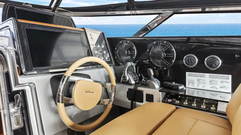 Wegu The Great Yacht Photos Pics 2023 Riva Dolceriva yacht cockpit with modern steering and navigation controls, overlooking the ocean.