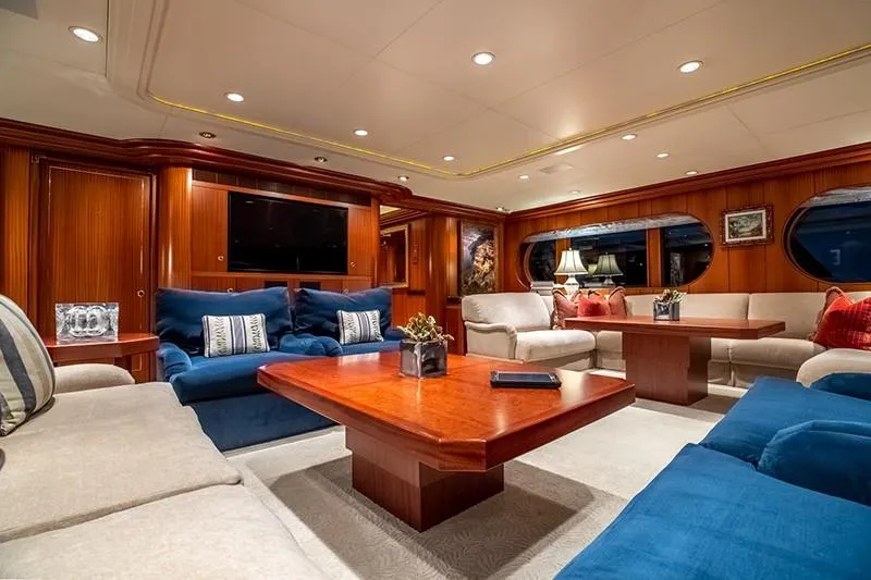 Never Enough Yacht Photos Pics Luxurious interior of 1992 Feadship 140 Tri-Deck yacht with elegant seating and wooden accents.