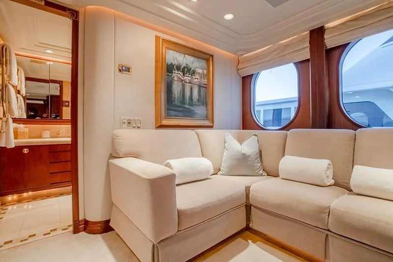 Never Enough Yacht Photos Pics Luxurious interior of 1992 Feadship 140 Tri-Deck yacht with plush seating and elegant decor.