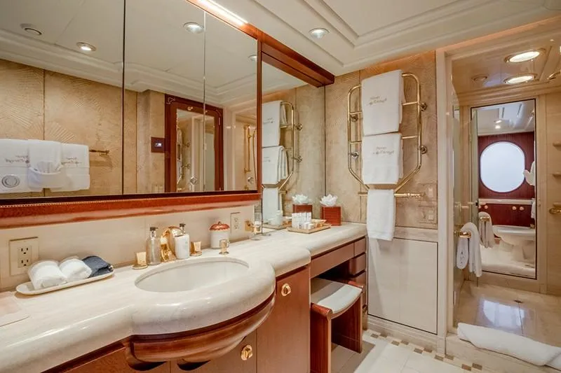 Never Enough Yacht Photos Pics Luxurious bathroom on a 1992 Feadship 140 Tri-Deck yacht with elegant fixtures and marble countertop.
