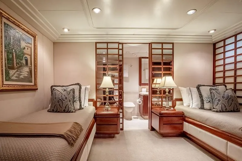 Never Enough Yacht Photos Pics Luxurious twin bedroom on 1992 Feadship 140 Tri-Deck yacht with elegant decor.