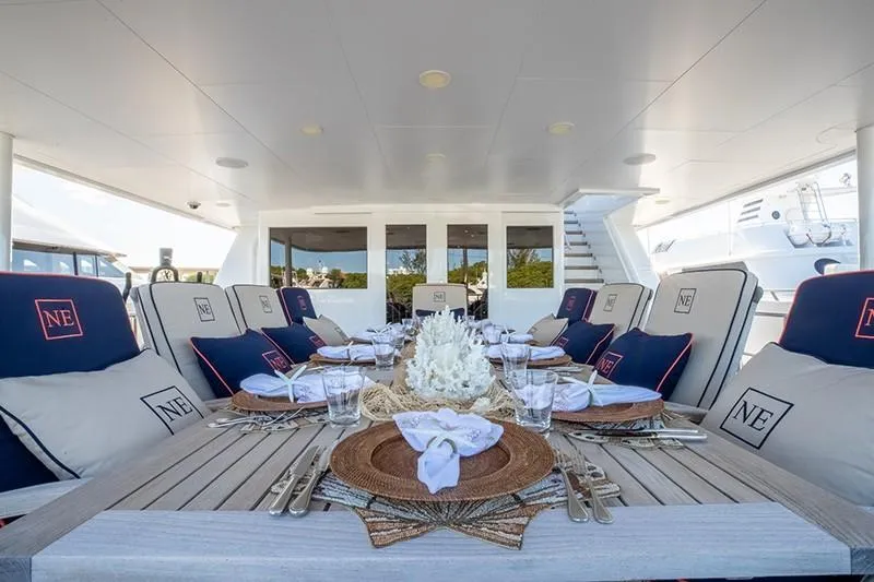 Never Enough Yacht Photos Pics Luxurious dining area on a 1992 Feadship 140 Tri-Deck yacht, elegantly set table.
