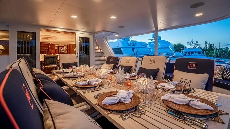Never Enough Yacht Photos Pics Luxurious dining area on the 1992 Feadship 140 Tri-Deck yacht, elegantly set for dinner.