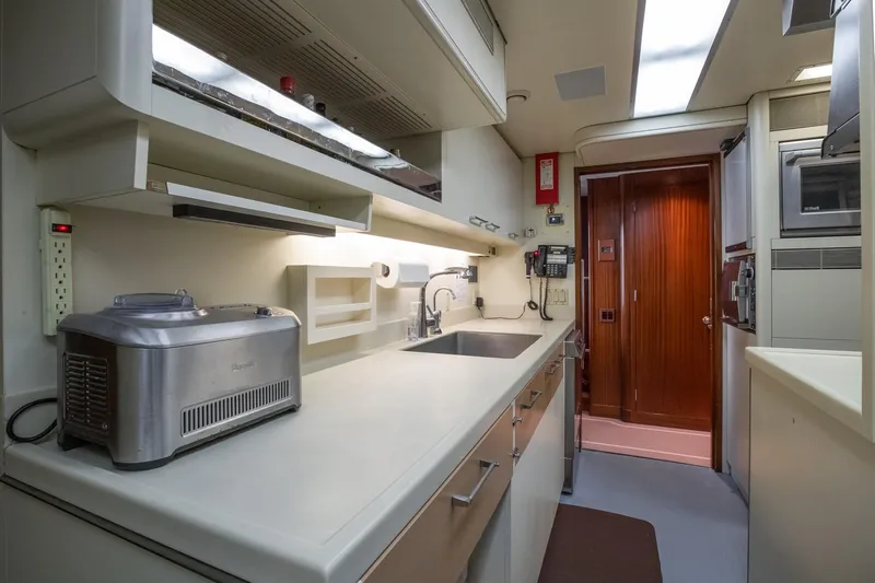 Never Enough Yacht Photos Pics Feadship 140 Tri-Deck 1992 yacht kitchen with modern appliances and ample counter space.