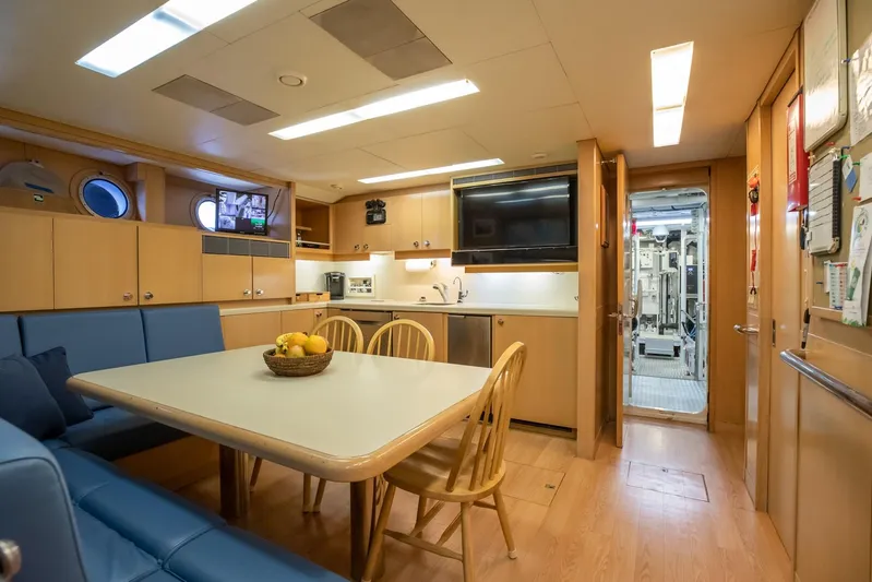 Never Enough Yacht Photos Pics Interior of 1992 Feadship 140 Tri-Deck yacht with dining area and kitchen.