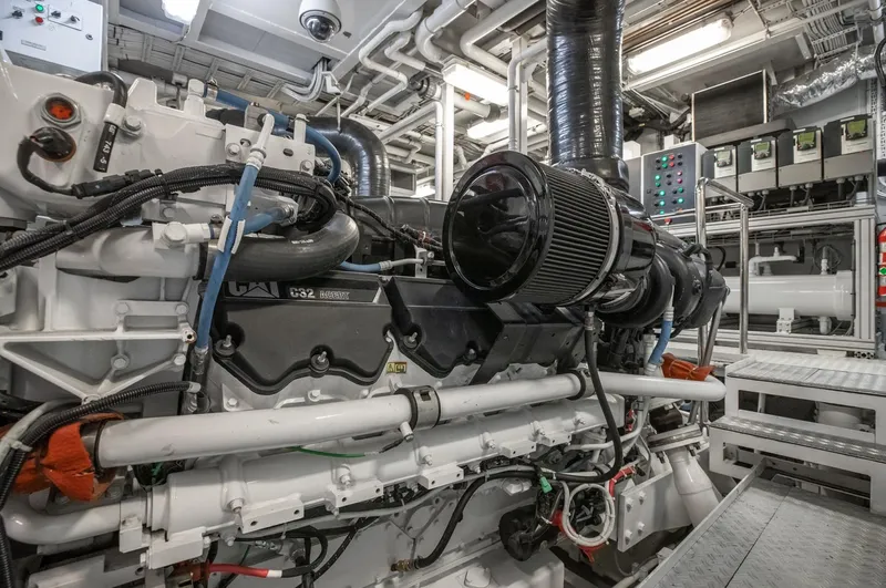 Never Enough Yacht Photos Pics Engine room of a 1992 Feadship 140 Tri-Deck yacht with complex machinery.