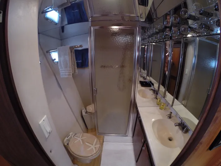 Wined Up Yacht Photos Pics Bathroom interior of a 1973 Hatteras 53 yacht with shower and sink.