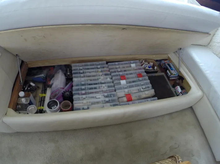 Wined Up Yacht Photos Pics Under-seat storage on 1973 Hatteras 53 yacht, organized with various tools and supplies.