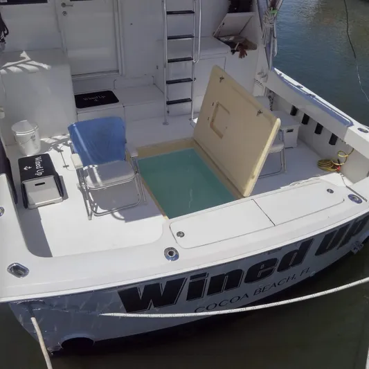 Wined Up Yacht Photos Pics 1973 Hatteras 53 yacht with open hatch, deck chairs, and ladder in Cocoa Beach, Florida.