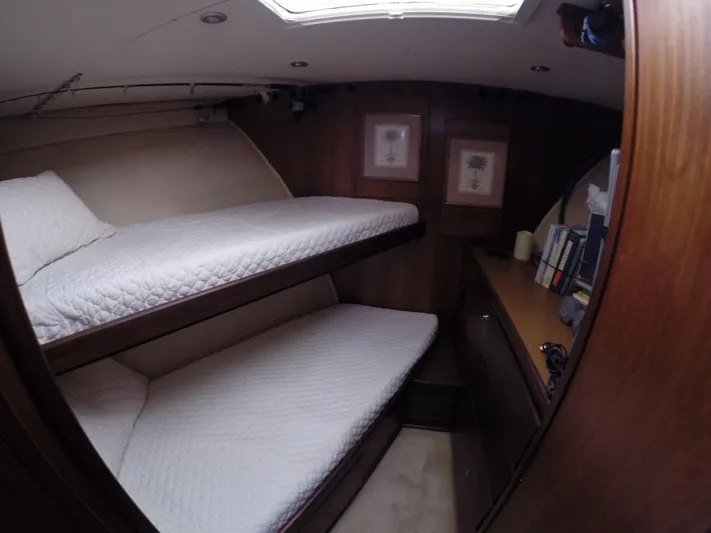 Wined Up Yacht Photos Pics Interior of 1973 Hatteras 53 yacht with cozy bunk beds and wooden cabinetry.
