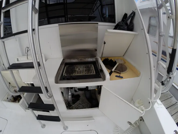 Wined Up Yacht Photos Pics Outdoor kitchen area on a 1973 Hatteras 53 yacht, featuring a grill and storage compartments.