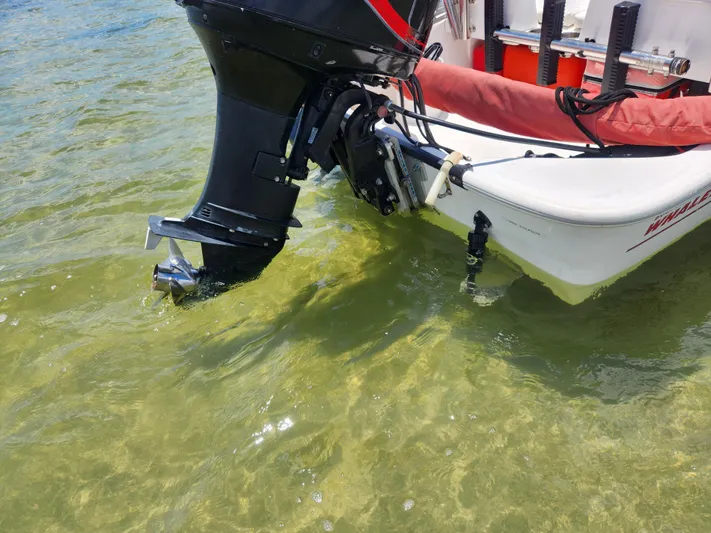 Wined Up Yacht Photos Pics Outboard motor on a Hatteras 53 boat, 1973 model, in clear shallow water.