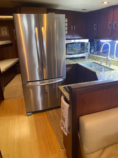 Wined Up Yacht Photos Pics Interior of 1973 Hatteras 53 yacht kitchen with stainless steel appliances and granite countertops.