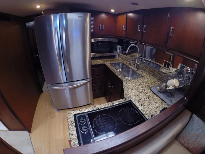 Wined Up Yacht Photos Pics Luxurious kitchen in a 1973 Hatteras 53 yacht with granite countertops and stainless steel appliances.