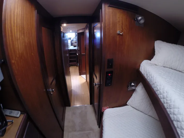 Wined Up Yacht Photos Pics Interior of a 1973 Hatteras 53 yacht with wooden paneling and cozy bunk beds.