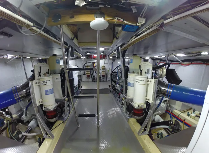 Wined Up Yacht Photos Pics Engine room of a 1973 Hatteras 53 yacht, showcasing mechanical components and equipment.