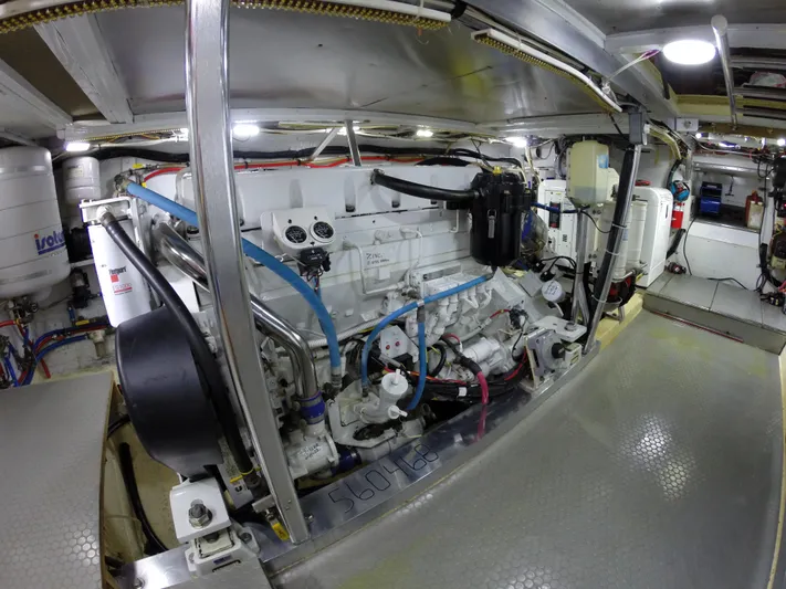 Wined Up Yacht Photos Pics Engine room of a 1973 Hatteras 53 yacht, showcasing mechanical components and systems.