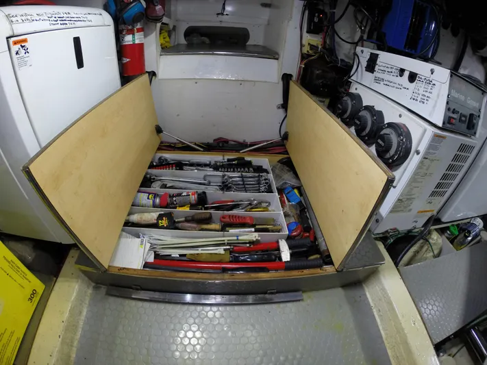 Wined Up Yacht Photos Pics Engine room of a 1973 Hatteras 53 yacht with open tool storage.