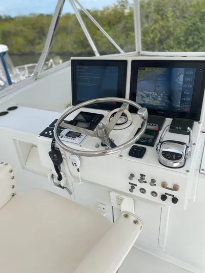 Wined Up Yacht Photos Pics Helm of a 1973 Hatteras 53 yacht with modern navigation equipment and controls.