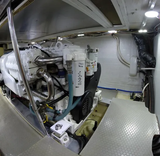 Wined Up Yacht Photos Pics Engine room of a 1973 Hatteras 53 yacht, showcasing mechanical components and piping.