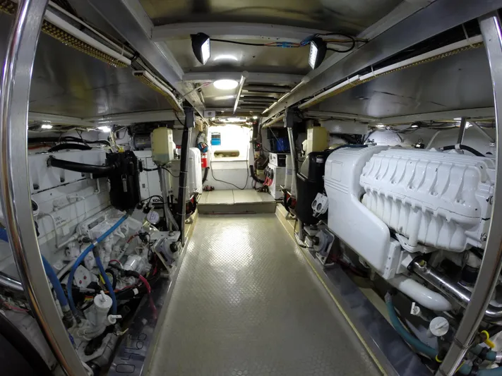 Wined Up Yacht Photos Pics Engine room of a 1973 Hatteras 53 yacht, showcasing dual engines and mechanical systems.