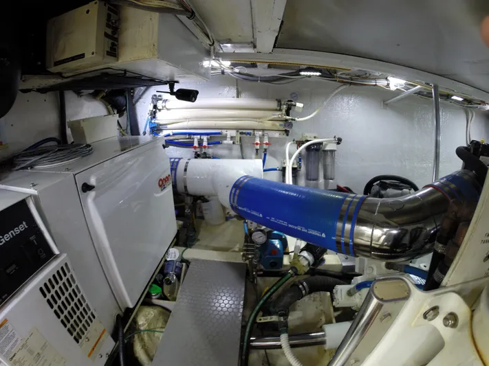 Wined Up Yacht Photos Pics Engine room of a 1973 Hatteras 53 yacht with mechanical equipment and piping.